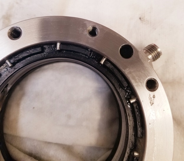 Figure 2: This is the drilling fluid side of the used PN 701-10-11 seal before extraction from the seal carrier. The radial pins engage molded rubber tangs on the seal to prevent circumferential slippage.