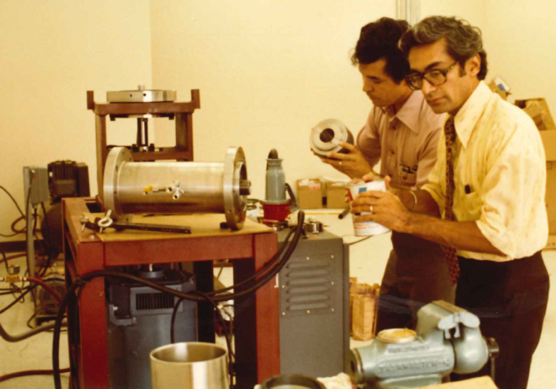 In this 1981 photo, Dr. Kalsi (right) and Daniel Alvarez are part way through the process of assembling Kalsi Engineering’s first seal test fixture. The laboratory was a small rented storefront. This fixture was used to develop and characterize our first commercially successful rotary sealing product.