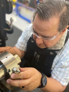 Figure 1: An engineer assembling a rotary shaft seal test.