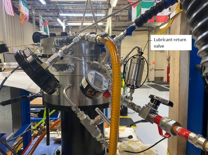 Figure 4 An RCD seal test fixture setup with the small lubricant return valve being tested with a BDRP seal and a barrier seal. A small compensating piston is connected on the other side of the fixture.